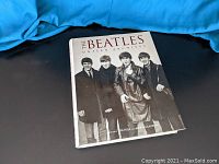 Front cover of the book showing a black and white photo of the Beatles
