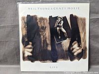 Front cover of the Neil Young & Crazy Horse Life vinyl album showing artwork with Neil Young photo.