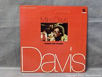 Front cover of the double vinyl album 'Miles Davis Workin' and Steamin'' with red background and photo of Miles Davis.
