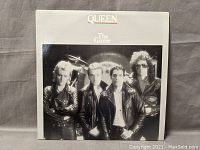 Front cover of Queen The Game vinyl album showing band members in leather jackets.