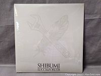 Front cover of sealed vinyl album 'Shibumi' by Lucci & Ford78, showing crossed wrench and feather symbol with title text.