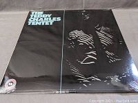Front cover of The Teddy Charles Tentet vinyl LP in sealed plastic wrap showing album title and abstract design.