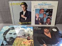 Photo showing front covers of five new sealed vinyl records by Peter Schilling, Jackie Gleason, Melanie, Jean-Luc Ponty, and Stevie Woods.