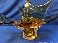 Side angle view showing the amber to clear glass gradient and the asymmetrical, organic design with multiple pointed peaks.