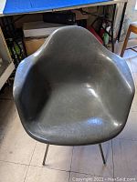 Front view of gray fiberglass shell seat and armrests