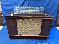 Front view of vintage Philips tube radio showing wood cabinet and speaker grille.