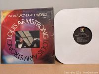 Vinyl record partially pulled out of white protective inner sleeve showing label details.