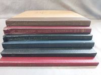 Stack of classical 78 RPM record albums in various colors showing edges and gold embossed/pushed text including Tchaikovsky Concerto in D Minor and others.