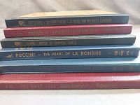 Stack of record album spines showing titles and artists such as 'An Invitation - A Pons-Kostelanetz Concert,' 'Music of Morton Gould,' 'Puccini - The Heart of La Bohème,' 'Sibelius Symphony No. 2,' and 'The Swan Lake Ballet Excerpts by Tchaikovsky.'