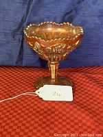 Marigold carnival glass compote with octagon pattern viewed from front with price tag.