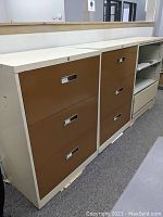 Front view of two beige and brown lateral file cabinets and one beige cabinet with shelving, showing drawer fronts and cabinet edges.