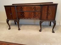 Full front view of the wooden buffet showing its structure and overall condition.