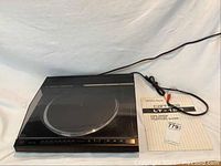 Full view of Carrera LT-120 turntable with dust cover closed and power cord attached.
