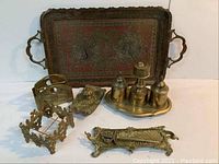 Overview of entire 6-piece set of brass desk accessories including tray, letter holder, stamper set, and desk caddy
