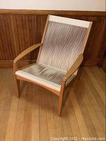 Front view of lounge chair showing overall design and rope webbing
