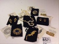 Overview of eight-piece lot on white background with black pouches and cards