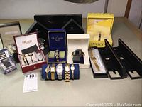 Overview of multiple boxed and loose watches on table