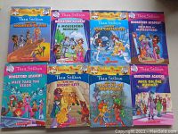 18 paperback children's books from Geronimo Stilton and Thea Stilton series, arranged for viewing.