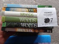 Six DVD cases from the TV series Weeds stacked together with visible titles and season indicator.