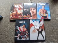 Five DVD cases of the Rocky movie series, showing front covers from Rocky 1 through Rocky 5.