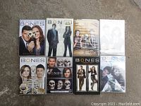 Eight DVDs of the Bones TV series showing covers with main characters and skeletal imagery, including the final chapter and special editions.