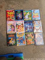 Photo of 12 Disney and one non-Disney DVD cases arranged on floor.