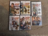 Six DVD cases of Lonesome Dove with one additional DVD titled 'Lonestar'