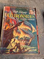 Front cover of 1960 Dell Walt Disney comic book Old Ironsides featuring Johnny Tremain with detailed illustrated scene of ships and figures.