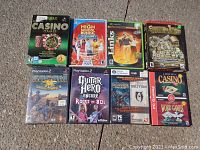 Photo of nine video and computer game cases including Casino, High School Musical, Links, Mahjong, Sudden Strike 2, Guitar Hero, Game of Thrones, Oblivion, and Casino & Word Games.