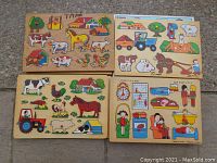Top view of four wooden peg puzzles with farm animals, tractor, house, and people scenes.