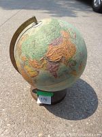 Side view photo of the textured Replogle globe showing detailed textured continents and countries in several colors.