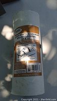 Roll of brown and white aluminum rolled flashing 10x10 with label showing product and installation details.