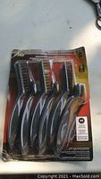 Pack of six Duramax cleaning brushes with black curved handles, assorted bristle types, packaged in clear blister pack on branded cardboard backing.