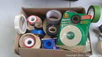 Box with various rolls of tape for electrical, plumbing, masking, and drywall use