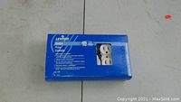 Box of 10 Leviton electrical outlets in blue packaging labeled with product information and quantity.