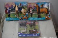 Photo showing two boxed character and horse sets from Spirit Riding Free, Marcella & Mitten and Lucky & Spirit, along with a boxed set of four horse figurines called Spirit's Herd.