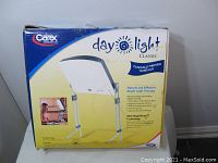 Box of Carex Daylight Classic Bright Light Therapy Lamp, with image and text describing bright light therapy benefits.