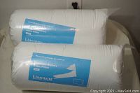Two pillows in original plastic packaging with blue Linenspa shredded memory foam labels