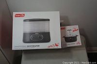 Photo of the Dash Smartstore Food Dehydrator box and the Dash Express Egg Cooker box side by side on a table.
