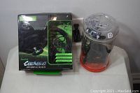 Photo of boxed Razer BlackShark V2 headset and sealed joystick container side by side on a white surface.