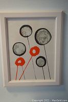 Full frontal photo of the framed lithograph showing abstract balloons in red and grey on white background.