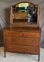 Front view of antique dresser with large mirror, showing drawer and mirror details