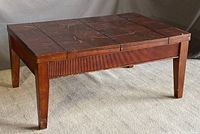 Closed wooden coffee table with visible surface marks and wear.