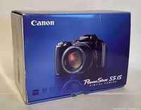 Original blue box of Canon PowerShot S5 IS digital camera showing product image and resolution specifications.