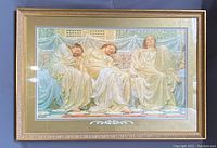 Front view of the large framed print depicting three classical figures in golden robes sitting on a patterned carpet.