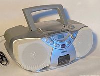 Front and side view of Philips portable audio system with speaker grilles and handle, showing overall condition and design.