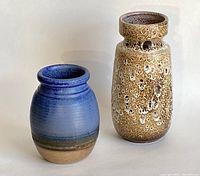 Photo of both vases side by side on plain background showing size and color contrast