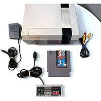 NES console with game cartridge, controller, power adapter, and AV cable laid out on white surface.