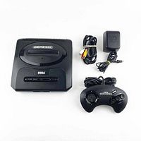 Sega Genesis Model 2 console with wired controller, power adapter, and AV cable arranged on white surface.