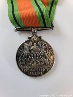 Reverse view showing the crowned royal coat of arms and inscription.